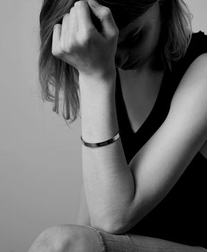 wide and flat bangle worn on a model