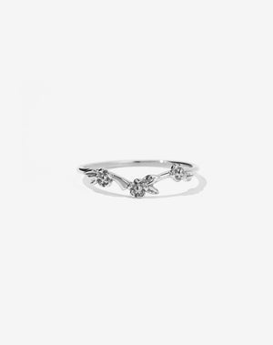 A sterling silver band ring with three blossoming flowers around a curve