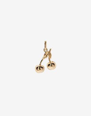 A 23k gold plated charm in the shape of two cherries attached by a small gold loop.