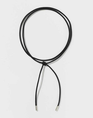 A black fabric cord necklace with metal tips.