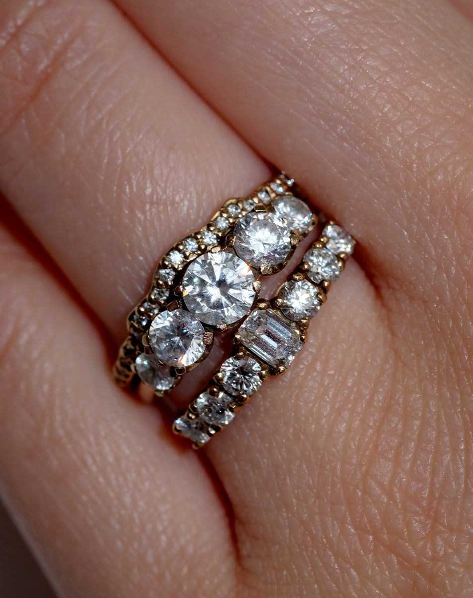 Meadowlark Jewellery’s classic Signature 5 Stone Engagement Ring in 9ct Yellow Gold, with 1.09ct round brilliant cut white diamonds. Set into our signature Meadowlark claw setting, featuring graphic lines inspired by our insignia. Pair with our bestseller, the Amelie Band Pave or Plain. One of our most timeless and beloved Ceremonial designs, made in New Zealand. Worn on model with the Eternal Wedding Band Pave and Amelia Engagement Ring.