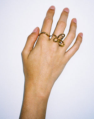 Gold rings on hand, flower ring, twisted halo band