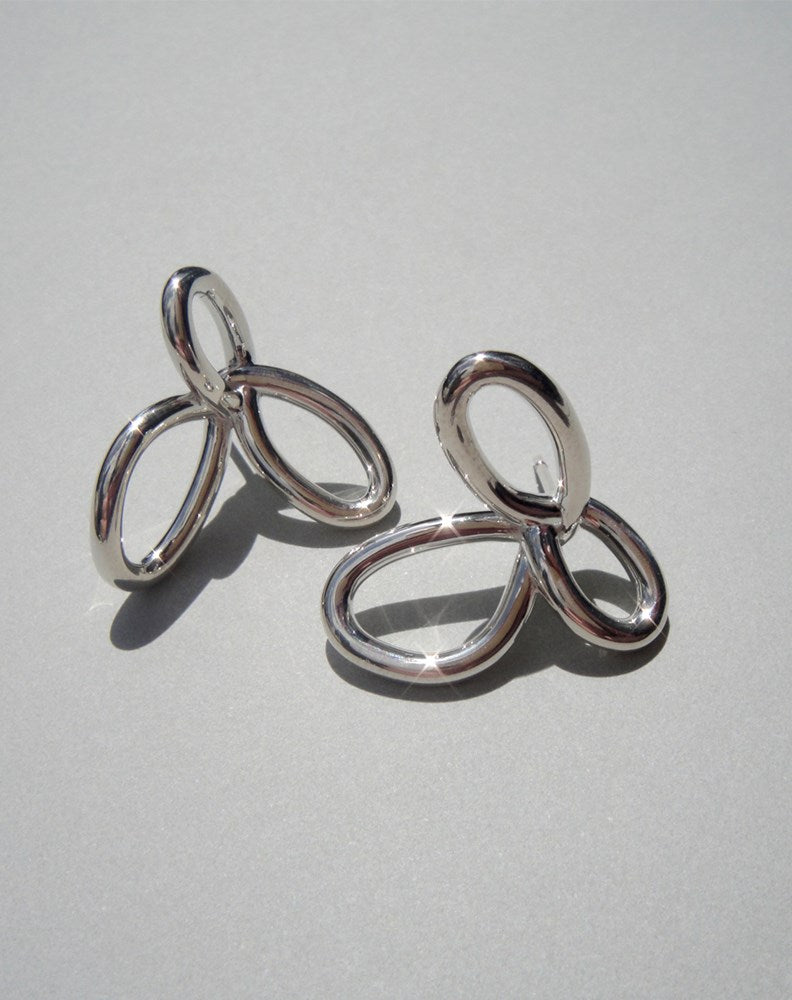 Silver flower earrings in a modern looping style
