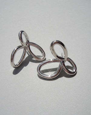 Silver flower earrings in a modern looping style