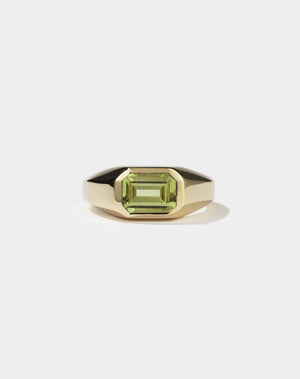 A gold ring with a Peridot gemstone on a white background. Made by Meadowlark Jewellery in New Zealand.