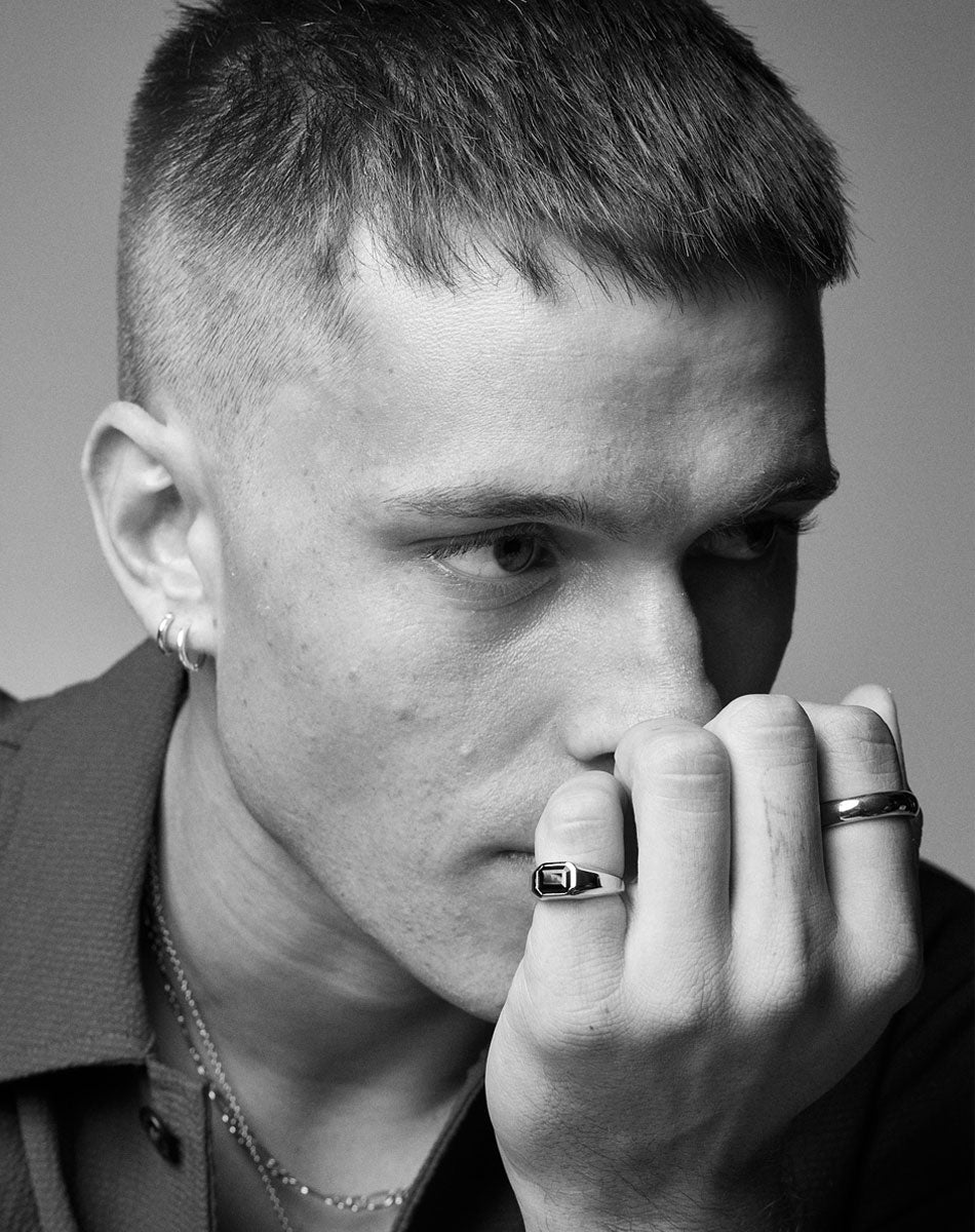 A black and white image of a model wearing a Milan Ring by Meadowlark Jewellery. 
