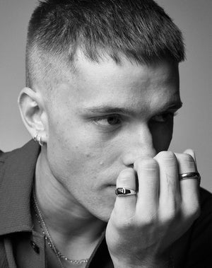 A black and white image of a model wearing a Milan Ring by Meadowlark Jewellery. 