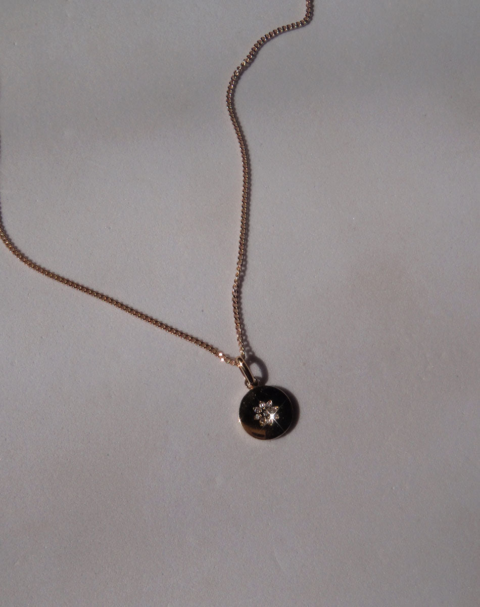 Violet Necklace with floral engraving in 9ct Yellow Gold. Set with White Diamond. 11m diameter pendant. 40cm or 45cm diamond curb chain.