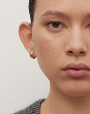 Coco Hoops Small Earrings in 23k Gold Plated or 9ct Yellow Gold, featuring a double hoop and lever or clicker back earring closure. Inner diameter approximately 7.5mm. Worn on model. 