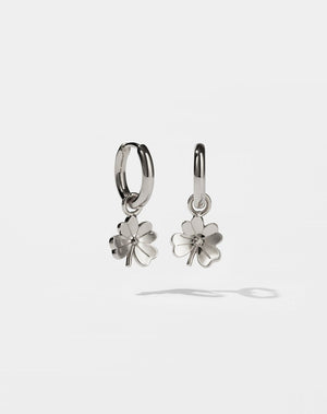 Silver four leaf clover shaped earrings on a white background