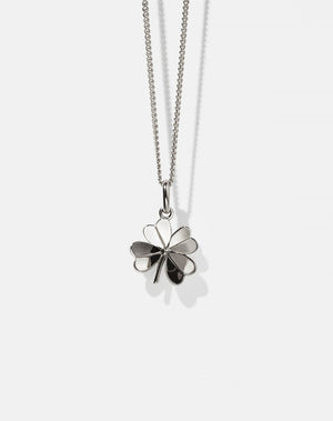 Silver necklace with a four-leaf clover pendant on a white background
