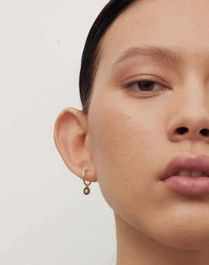 Lulu Signature Hoop Earrings in 23k Gold Plated or 9ct Yellow with star set White Diamond. 6mm in diameter. Worn on model.