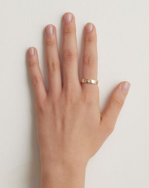 Lulu Star Band in 9ct Yellow Gold with star set round brilliant cut White Diamond. 4.5mm width wedding band. Worn on model hand.