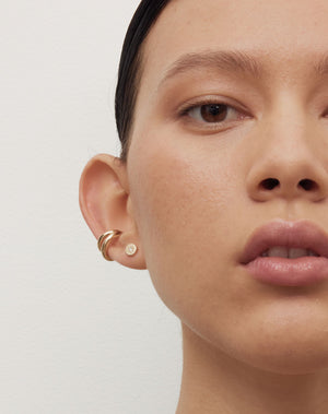 Lulu Stud Earrings in 23k Gold Plated or 9ct Yellow Gold with star set White Diamond. 6mm in diameter. Worn on model, stacked with Coco Ear Cuff Medium in 23k Gold Plated.