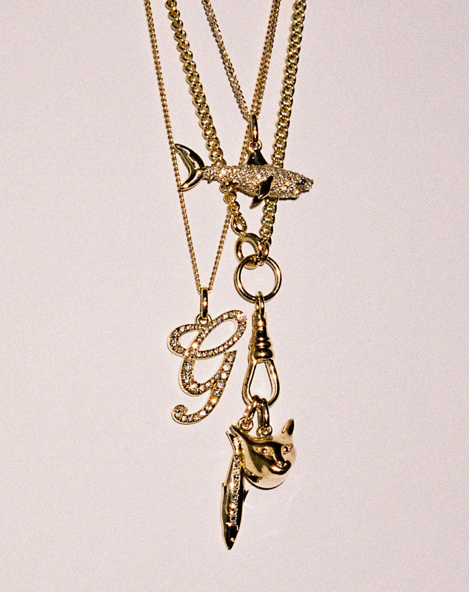 Layered Gold charm necklaces with diamonds. Shark charm,  cat charm,  sardine charm.