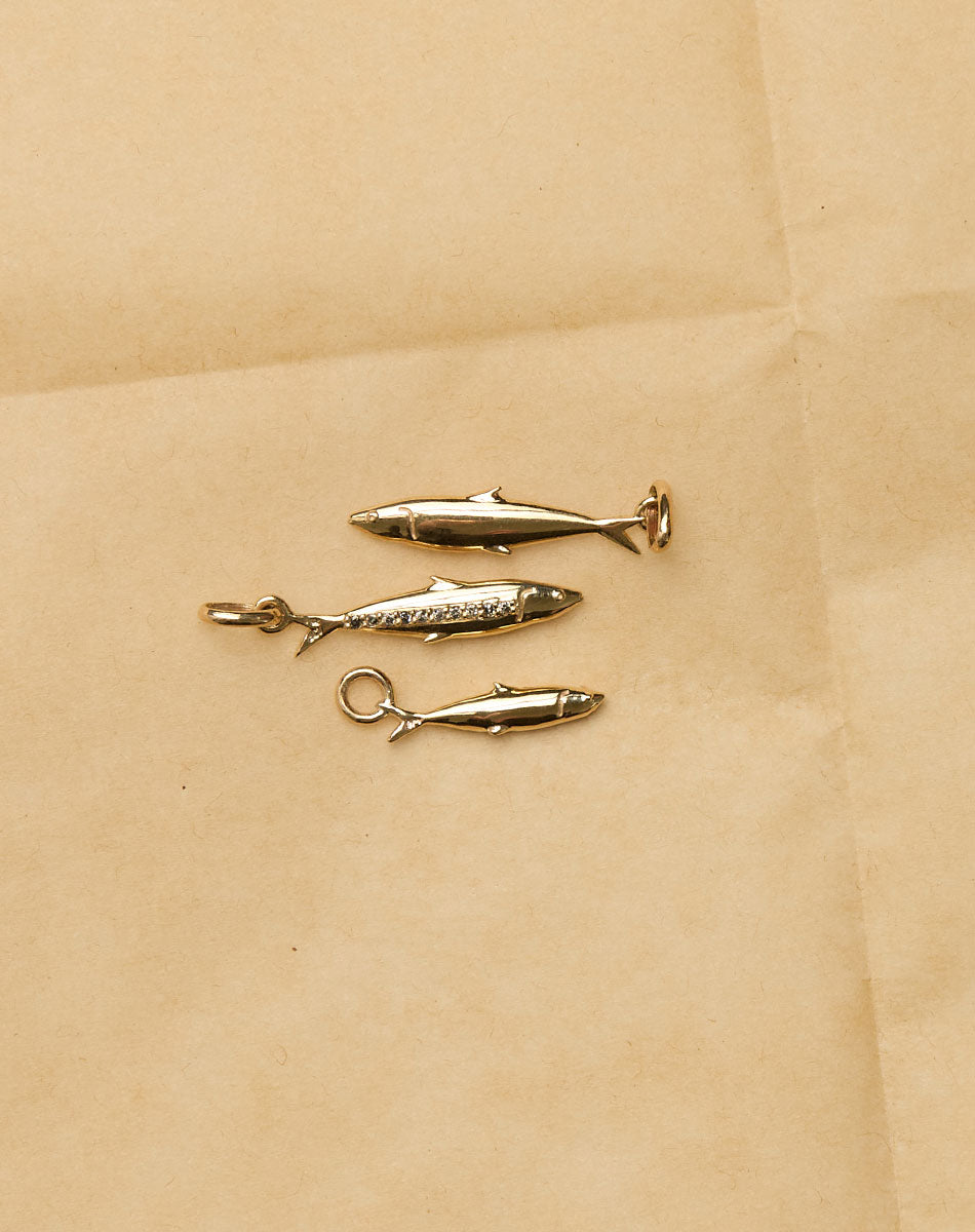 Three gold sardine charms 