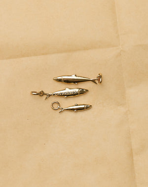 Three gold sardine charms 