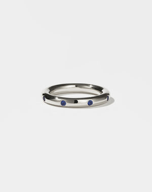 Silver ring with blue sapphires stones on a white background