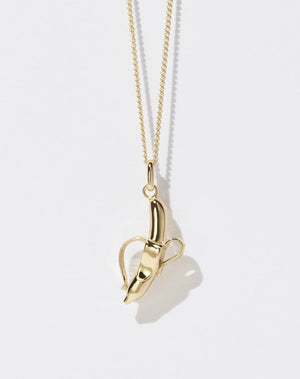 A 23k gold plated banana-shaped charm necklace on a fine gold chain.