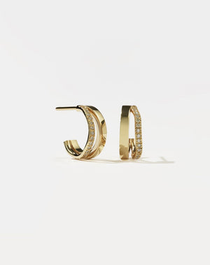 A pair of gold hoop earrings, pavé set with diamonds.