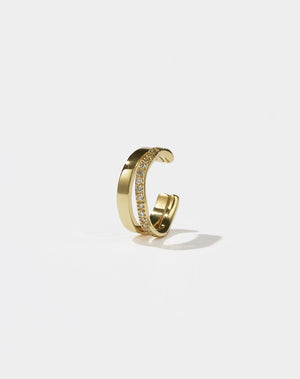 A gold-colored hoop ear cuff with a pavé set of diamonds 