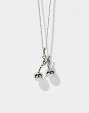 A sterling silver necklace featuring a cherry-shaped pendant on a fine chain.