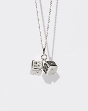A sterling silver necklace featuring two dice charms attached to a fine chain.