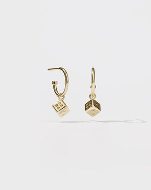 A pair of gold hoop earrings with dice charms attached