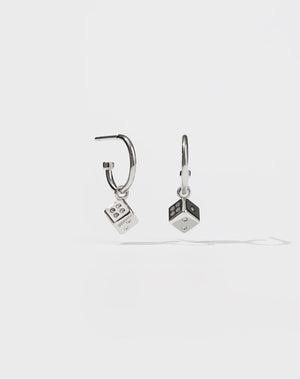 A pair of sterling silver hoop earrings with dice charms attached