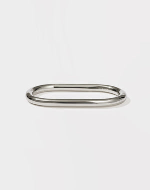 A minimalist round and endless sterling silver band designed to fit across two fingers.