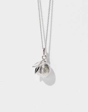 A sterling silver necklace with a lemon charm, suspended from a fine chain.