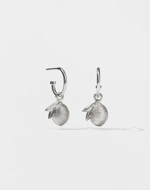A pair of sterling silver hoop earrings with a lemon charms attached