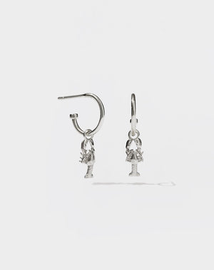 A pair of sterling silver hoop earrings with lobster charms attached