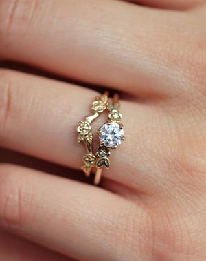 Meadowlark Jewellery’s iconic Alba Engagement Ring in 9ct Yellow Gold, claw set with a 0.50ct round brilliant cut white diamond. Round band adorned with flowers, set with round brilliant cut white diamonds. Pair with our bestseller, the Alba Band Stone Set or Plain. Made in New Zealand. Worn on model.