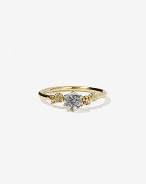 Meadowlark Jewellery’s iconic Alba Engagement Ring in 18ct Yellow Gold, claw set with a round brilliant cut grey diamond. Round band adorned with flowers, set with round brilliant cut grey diamonds. Pair with our bestseller, the Alba Band Stone Set or Plain. Made in New Zealand.