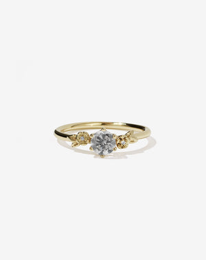 Meadowlark Jewellery’s iconic Alba Engagement Ring in 9ct Yellow Gold, claw set with a round brilliant cut grey diamond. Round band adorned with flowers, set with round brilliant cut grey diamonds. Pair with our bestseller, the Alba Band Stone Set or Plain. Made in New Zealand.