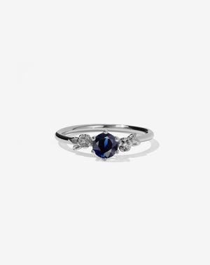 Meadowlark Jewellery’s iconic Alba Engagement Ring in Platinum, claw set with a round brilliant cut blue sapphire. Round band adorned with flowers, set with round brilliant cut white diamonds. Pair with our bestseller, the Alba Band Stone Set or Plain. Made in New Zealand.