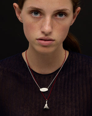 Meadowlark Jewellery’s Blessed Necklace and Magda String Necklace in Sterling Silver. A meaningful talisman for life’s journey, to serve as a daily reminder to honour the present and embrace gratitude for the quiet abundance all around us. A classic name tag in a matte, brushed texture inspired by ancient heirlooms hung from a fine diamond curb chain. From the Dreams collection.