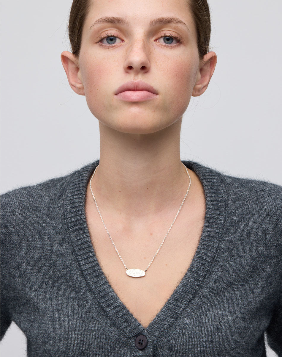 Meadowlark Jewellery’s Blessed Necklace in Sterling Silver. A meaningful talisman for life’s journey, to serve as a daily reminder to honour the present and embrace gratitude for the quiet abundance all around us. A classic name tag in a matte, brushed texture inspired by ancient heirlooms hung from a fine diamond curb chain. From the Dreams collection.