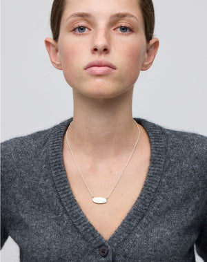 Meadowlark Jewellery’s Blessed Necklace in Sterling Silver. A meaningful talisman for life’s journey, to serve as a daily reminder to honour the present and embrace gratitude for the quiet abundance all around us. A classic name tag in a matte, brushed texture inspired by ancient heirlooms hung from a fine diamond curb chain. From the Dreams collection.