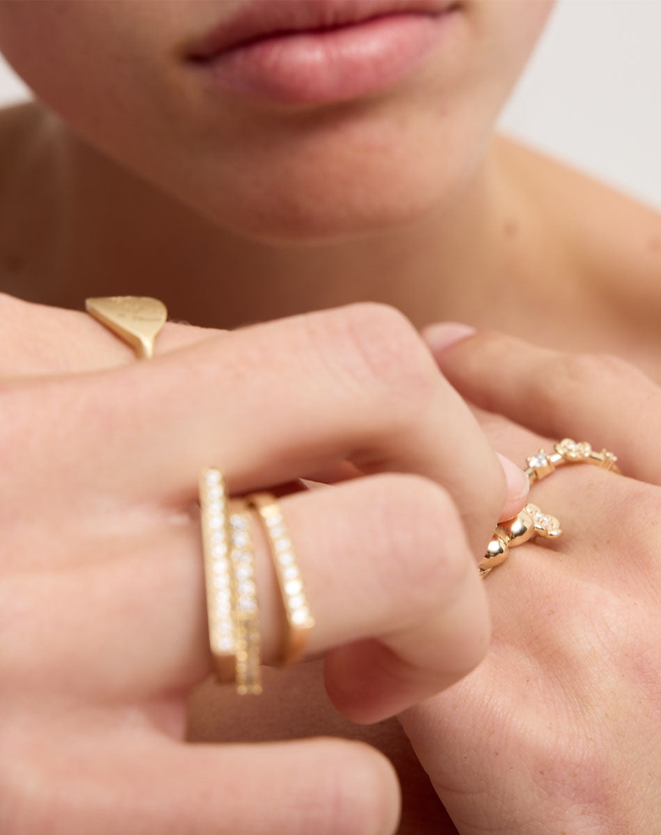 Meadowlark Jewellery’s architectural Geo Ring Flat in 9ct Yellow Gold, pave set with twelve round brilliant cut white diamonds atop a 1.5mm. A striking piece designed to be worn with the Geo Arc & Geo Point rings, or alone for a refined and minimal look. From the Dreams collection.