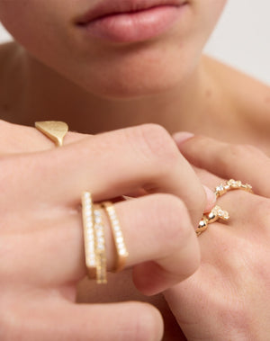Meadowlark Jewellery’s architectural Geo Ring Flat in 9ct Yellow Gold, pave set with twelve round brilliant cut white diamonds atop a 1.5mm. A striking piece designed to be worn with the Geo Arc & Geo Point rings, or alone for a refined and minimal look. From the Dreams collection.
