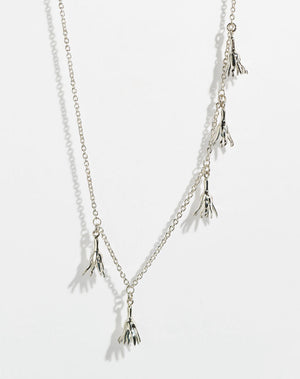 Meadowlark Jewellery’s Magda Five Charm Necklace in Sterling Silver. Five delicate, bell-shaped flower charms suspended from a fine diamond curb chain. A poetic celebration of growth, transformation, and the eternal rhythm of nature. A statement of quiet strength and beauty. From the Dreams collection.