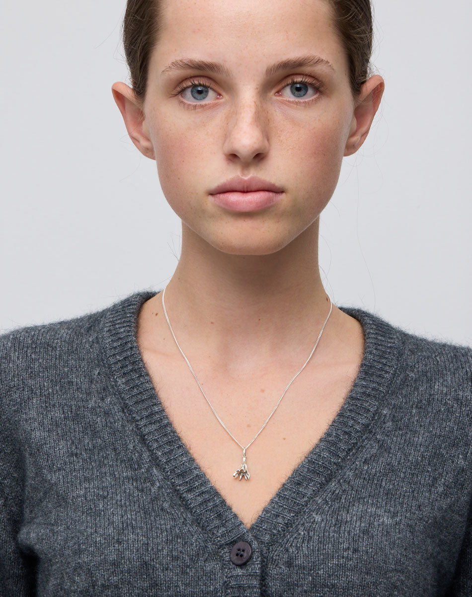 Meadowlark Jewellery’s Magda Charm Necklace in Sterling Silver. A single bell-shaped flower charm suspended from a fine diamond curb chain. A symbol of quiet transformation and the tender strength of nature. From the Dreams collection.