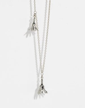 Meadowlark Jewellery’s Magda Two Charm Necklace in Sterling Silver. Two delicate, bell-shaped flower charms suspended from a fine diamond curb chain. A minimalist ode to blooming and the enduring cycles of life. From the Dreams collection.