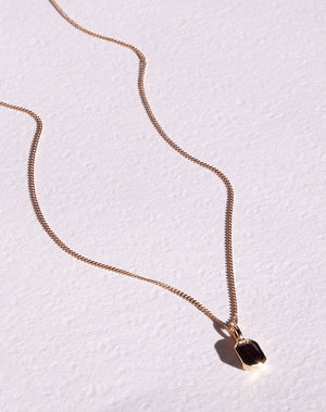 Meadowlark Jewellery's Limited Edition Milan Necklace in 9ct Yellow Gold with an emerald-cut Thai garnet stone held boldly in a distinctive bezel setting. Hung from a 40cm fine chain necklace. A classic and timeless design, perfect to stack with your favourite chains or a minimalist piece for everyday. Made to order in New Zealand, at the Meadowlark workshop.