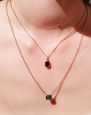 Meadowlark Jewellery's Limited Edition Milan Necklace in 9ct Yellow Gold with an emerald-cut green tourmaline and Thai Garnet stone held boldly in a distinctive bezel setting. Hung from an adjustable 40cm-45cm fine chain necklace. A classic and timeless design, perfect to stack with your favourite chains or a minimalist piece for everyday. Made to order in New Zealand, at the Meadowlark workshop.