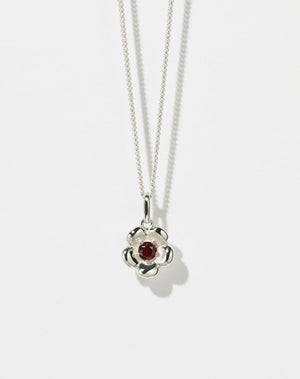 Meadowlark Jewellery’s floral Posie Charm Necklace in Sterling Silver, set with a single round brilliant cut African Garnet stone. Hung from a fine diamond curb chain. Inspired by classic floral motifs and our beloved Alba designs, a timeless symbol of grace, growth and renewal. Celebrating life’s continual renewal. From the Dreams collection.