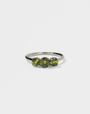 A classic three stone engagement ring in white gold with green sapphire.