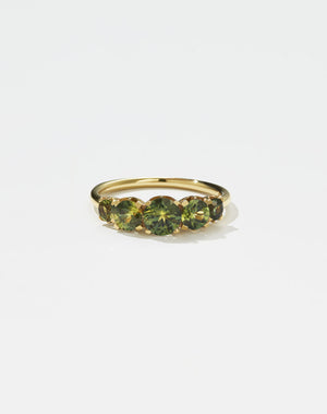 A classic yellow gold, five stone diamond engagement ring. Set with green sapphires.